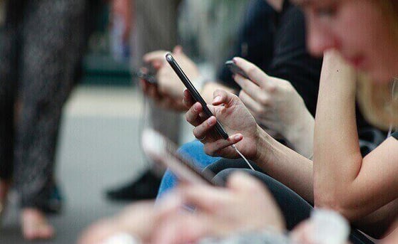 Users engaging on mobile devices, highlighting the importance of digital sales leads services for customer acquisition.