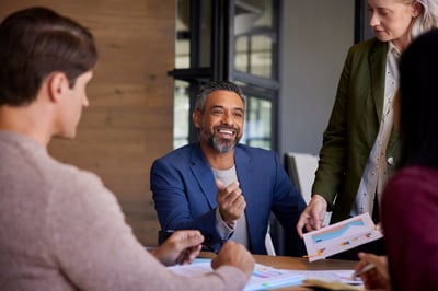 Business person talking with their sales team.