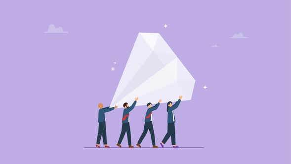Team pushing a large gem uphill symbolizing effort behind a valuable content marketing strategy.