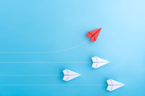 Group of paper plane in one direction and with one individual pointing in the different way. 