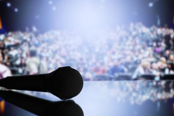 The microphone on the stage in front of the hall.