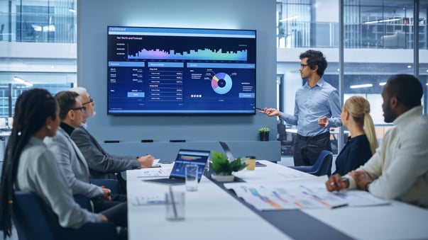Team reviewing marketing analytics dashboard with AI insights to guide data-driven decisions.