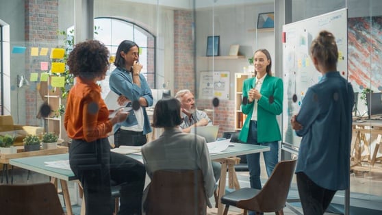 Team meeting highlights collaboration and the benefits of upskilling employees in a modern work environment.