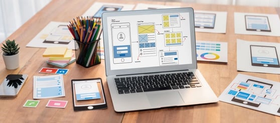 Laptop with website wireframe design showcasing what makes a website great through UI/UX planning.