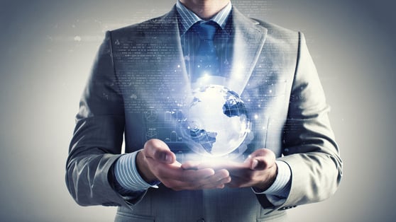 Businessman holding a glowing digital globe representing global impact and opportunities of the AI revolution.