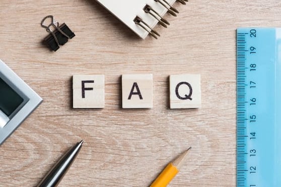 Image of desktop with FAQ in block letters on it.
