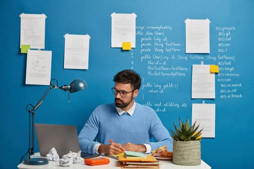 Content refreshing strategy with documents and a laptop on a desk for content updates.